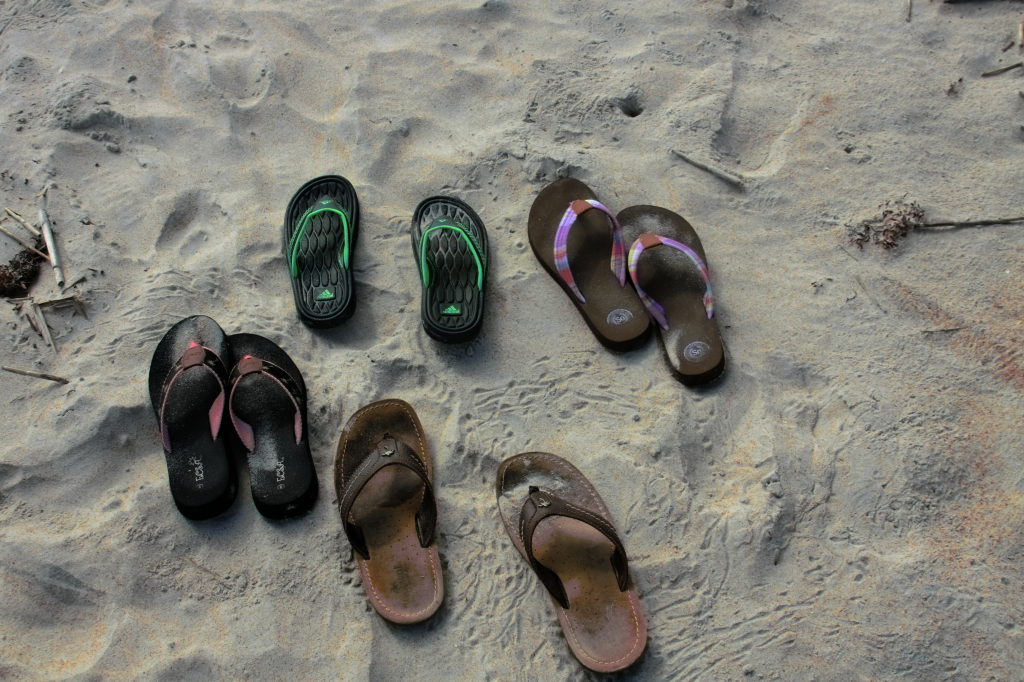 Sandals are left behind for a walk on the beach